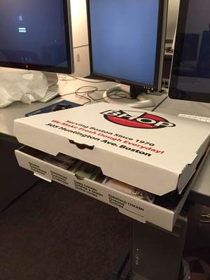 Closed Pizza box with project contents peeling out