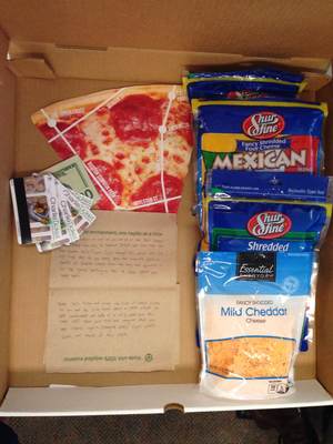 Open Pizza box with pizza map, bags of cheese, subway tickets, and instructions written on napkins